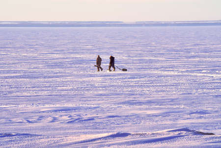 Novosibirsk, Siberia, Russia-04.03.2021: Fishermen on the winter Ob Sea. Fans of ice fishing go on the ice of the Novosibirsk reservoir away from the shoreのeditorial素材