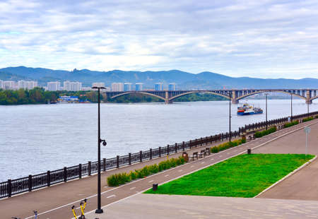Krasnoyarsk, Siberia, Russia-09.01.2021: Alexandrovsky Boulevard on the background of the Communal arch bridge among the hillsのeditorial素材