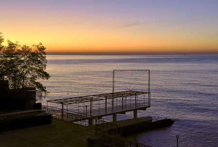 Berth on the Black sea in Yalta. Blue-gold sky before dawn, horizon line, without people. Russia, Crimea, 2019の写真素材