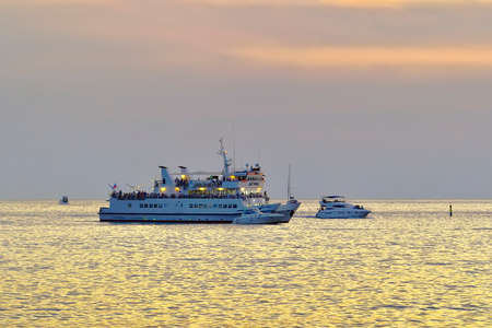 Sochi, Russia, 11.01.2021. Cruise ship "Dagomys" on the water in the evening among golden wavesのeditorial素材