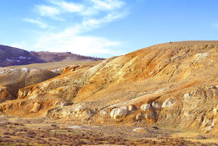 Mars in the Altai Mountains. The slope of the river valley with the exposure of colorful clays and siltstones under the blue sky is a geological attraction. Chui Valley, Siberia, Russiaの写真素材