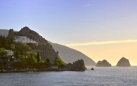 Hurzuf, Crimea, Russia-05.05.2019: Holiday home in Gurzuf rocks against the backdrop of mount Ayu-Dag early in the morning. Black sea, tourist resortのeditorial素材