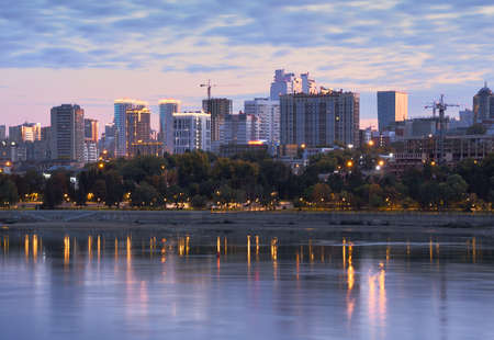 Novosibirsk, Siberia, Russia - 09.10.2019: Tall houses, cranes on the banks of the Ob river in...