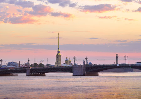 Saint Petersburg, Russia-09.01.2020: View of Peter and Paul Cathedral at dawn. Palace bridge on the background of pink dawn sky with clouds. Architecture of the XVIII centuryのeditorial素材