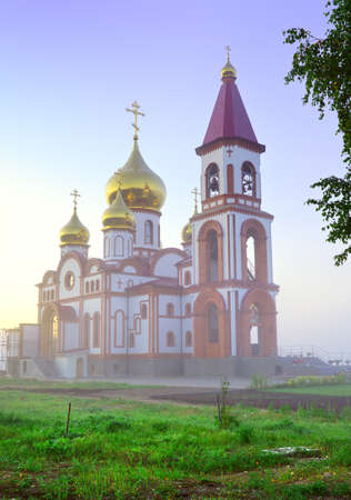 An Orthodox church under construction in the morning fog. Krasnoyarsk, Siberia, Russiaの写真素材