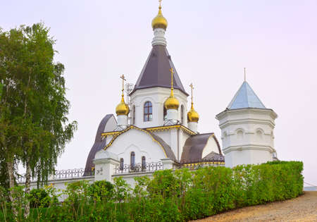 Tent Orthodox church behind the monastery fence on a foggy morning. Krasnoyarsk, Siberia, Russiaの写真素材