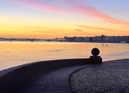Dawn over the Neva. View of the Trinity bridge and the Palace embankment from the spit of Vasilievsky island. Granite parapet with a stone ball. Saint Petersburg, Russia, 2020のeditorial素材