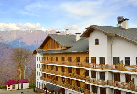 A mountain chalet with a triangular roof under a blue sky. Rosa Khutor, Sochi, Russia, 2021のeditorial素材