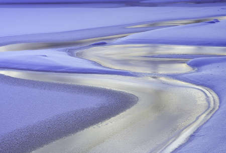 Blue ice and snow on the river in winter. Siberia, Russia