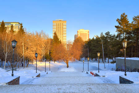 Novosibirsk, Siberia, Russia, 29.01.2022. Narymsky Square on a winter morning. Stairs to the park covered with snow surrounded by multi-storey buildingsのeditorial素材