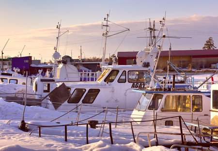 Novosibirsk, Siberia, Russia-04.03.2021: Boats and yachts in winter. White river boats spend the winter on the shore among large snowdriftsのeditorial素材