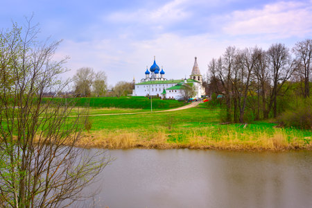 The old Kremlin on the river bank. Cathedral of the Nativity of the Virgin in the distance, architecture of the XIII-XVI centuries. Suzdal, Russia, 2022の写真素材
