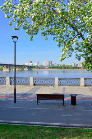 Novosibirsk, Siberia, Russia, 05/18/2022. Mikhailovskaya embankment of the Ob River. Benches on the promenade near the Oktyabrsky Bridgeの写真素材