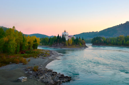 Altai, Siberia, Russia, 09/18/2022. Katun River Valley in the morning. Korona Altai Hotel on an island in the bed of a mountain riverのeditorial素材