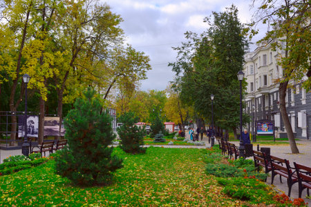 Pskov, Russia, 09.26.2022. Streets of the autumn city. Green square on Pushkin Street with autumn foliageのeditorial素材