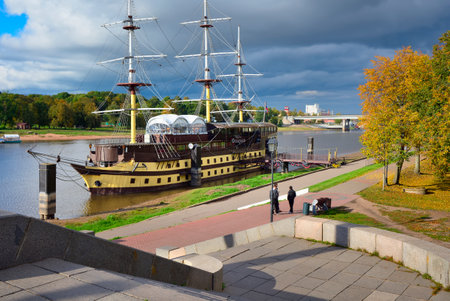Veliky Novgorod, Russia, 09.26.2022. Monuments of the old city. Embankment of the Volkhov River, sailboat cafe near the shore "Frigate Flagship"のeditorial素材
