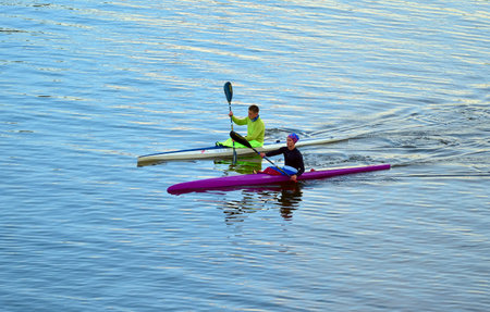 Veliky Novgorod, Russia, 09.26.2022. Sports kayaks on the water. Young rowers swim on the water of the Volkhov Riverのeditorial素材