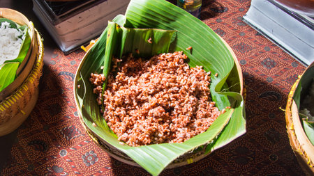 cooked brown rice, red rice, Rice Berry in a woven bamboo basket covered with banana leaves, organic food, healthy eatingの写真素材