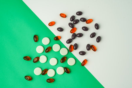 Many different tablet pills on color background, flat lay, with copy space.の写真素材