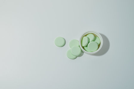 A bunch of medicinal pills and antibiotics, White medical tablets, light green, with copy space.の写真素材