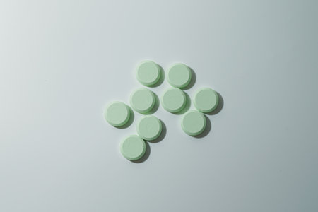 A bunch of medicinal pills and antibiotics, White medical tablets, light green, with copy space.の写真素材
