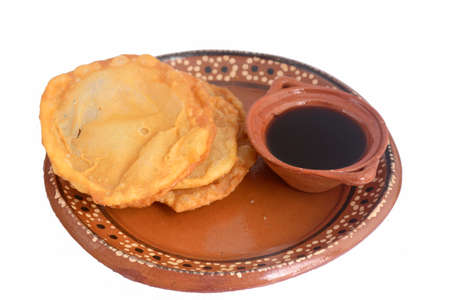 Mexican traditional fried dough buÃ±uelo with piloncillo syrup
