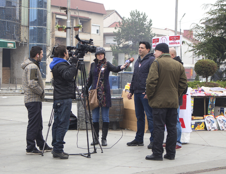 Kavadarci, Macedonia - November 27, 2016: Reporters is interviewing representatives of Macedonian party "Levica". Electoral campaign before parliamentary elections in Macedonia on December 2016.のeditorial素材