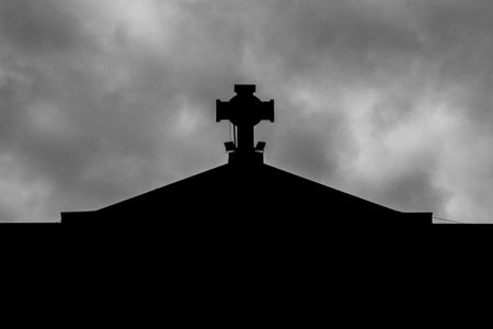a church cross on a cloudy day