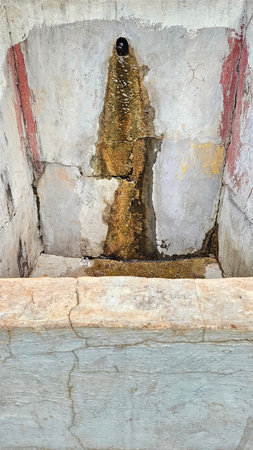 water spout leaking and worn, with several layers of paint showing, dirty, broken and moldyの写真素材