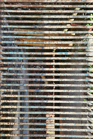 vintage iron grille with signs of rust and dirtの写真素材
