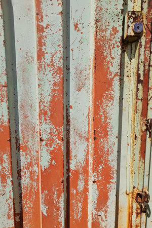 faded background in green and orange, with keyhole and rust spotsの写真素材