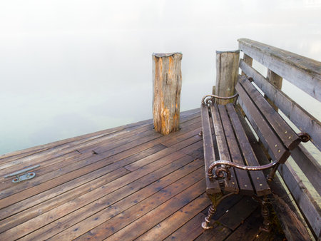 Wooden bench in fog on a pierの写真素材