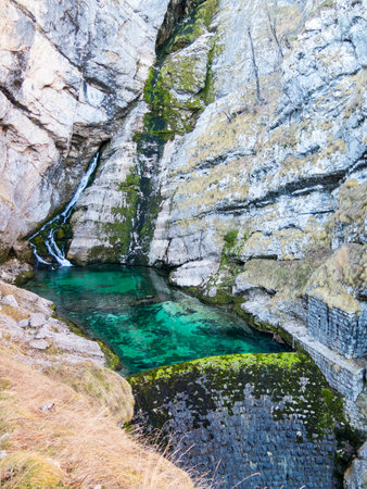 Small waterfall falling in lake with a damの写真素材