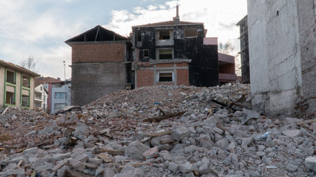 Earthquake damage in a city. Destroyed buildings after an earthquake. Collapsed buildings. Ruined city because of war. Airstrike damages a city. Urban transformation concept. Selective focus includedの写真素材
