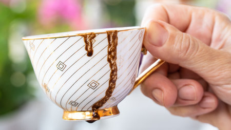 Fortune telling with coffee. Woman fortune teller predicting the future with coffee grounds.の写真素材