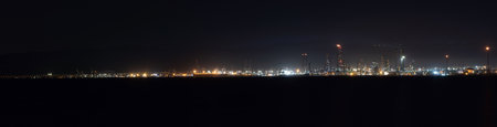 Panoramic view of industrial area at night in Gulf of Izmit Turkey. Factory lights at nightの写真素材