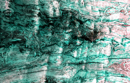 Weathered rock texture with turquoise abstract reflections. Stone surface with yellow colored shapes