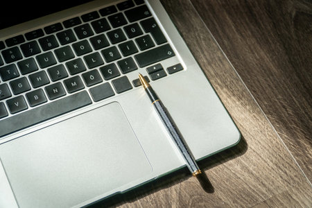 laptop and pen. Office desk high angle view. Working from home. Selective focus included.の写真素材