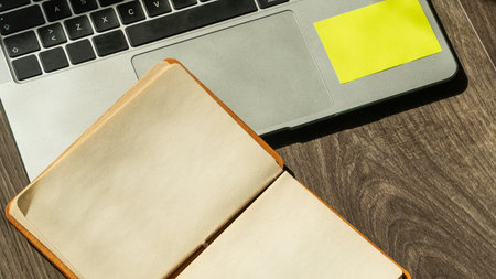 Laptop and notepad with blank pages. Blank note paper and laptop. Office desk concept high angle...