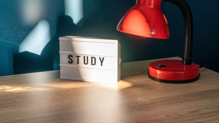 Study background concept. Study room concept. Wooden table or desk with lamp in a home with natural daylight. comfy workplace. Selective focus includedの写真素材