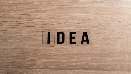 idea concept. 'Idea' word on a wooden table. Letters on a wooden table. Motivational or inspirational concept. high angle view.の写真素材