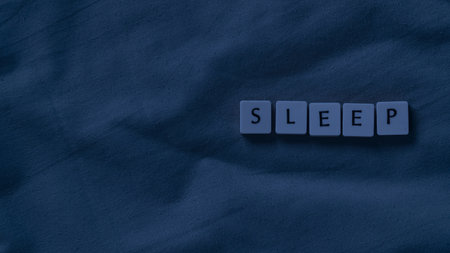 Sleep concept. Sleep lettering on a soft bed sheet. Copy space for text template for presentationの写真素材