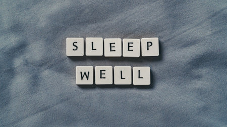 Sleep well words on a soft bed sheet. Sleep health concept. Copy space for textの写真素材