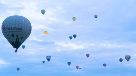 Cappadocia Turkey. Hot air balloons flying over fairy chimneys at sunrise in Cappadocia. Travel to Turkey. Touristic landmarks of Turkiye. Selective focus included.の写真素材