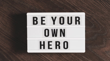 Be your own hero word on a letter board. Motivational quote concept. Motivational words on a white...