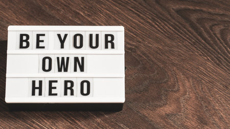 Be your own hero word on a letter board. Motivational quote concept. Motivational words on a white...