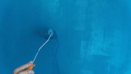 Painting wall. diy concept. Home interior improvement. Renovating house. Do it yourself concept. Selective focus includedの写真素材