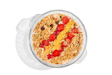 A refreshing and nutritious granola smoothie bowl topped with slices of ripe banana and fresh...