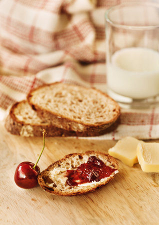 Fresh wholewheat bread with organic cherry jam for healthy breakfastの写真素材