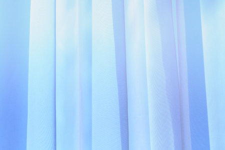 A wave of illuminated soft and gentle colored curtain made of lightweight fabric.の写真素材
